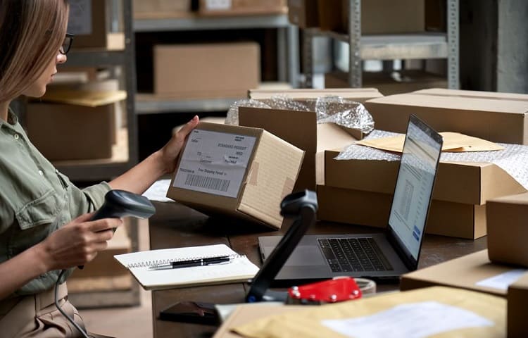 worker in post office scanning label